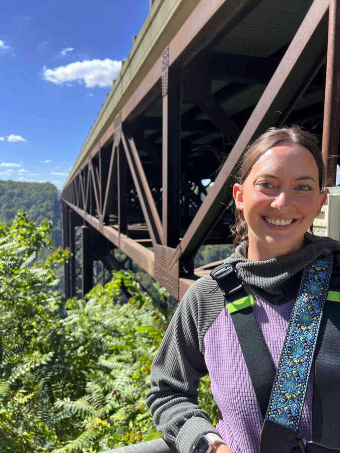 Walker smiling on the bridge catwalk