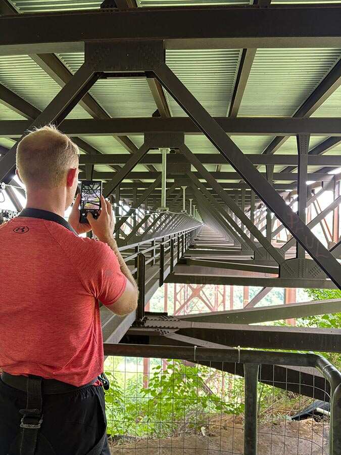 Walker photographing the catwalk stretching into the distance